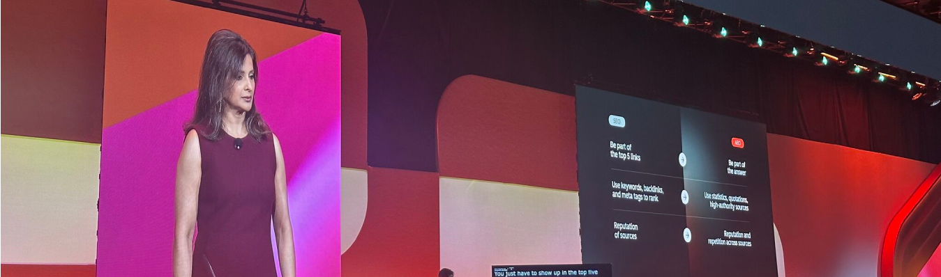 Yamini Rangan speaking on stage at INBOUND 2025, with a large screen behind her showing a comparison between traditional SEO strategies and modern AI-driven content strategies.