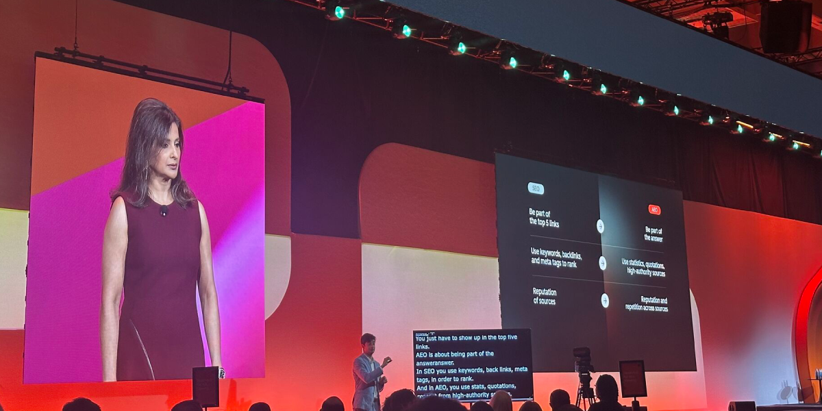 Yamini Rangan speaking on stage at INBOUND 2025, with a large screen behind her showing a comparison between traditional SEO strategies and modern AI-driven content strategies.